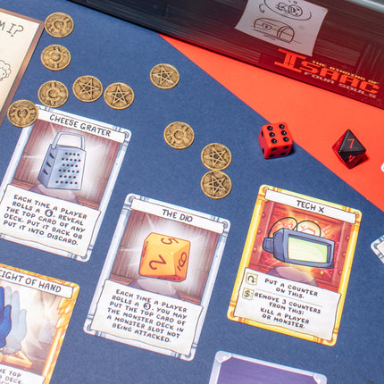 The Binding of Isaac Four Souls item cards and coins close up - House of Games
